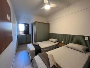 3 min Praia Grande, 2 suítes, Ar Condicionado, Churrasqueira e Piscina no Rooftop