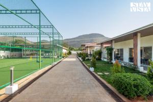 StayVista at The Grand Ten with lawn and pool