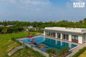 StayVista at Aarna Estate with library, lawn