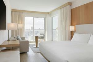 Corner Guest room with king bed, sofa bed, coast view and wraparound balcony room in AC Hotel by Marriott Fort Lauderdale Beach