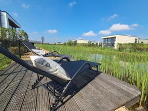 Marina Strandbad Chalet Land in Sicht mit Zaun Haus Nr 81