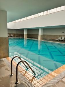 apartment tow bed room and living room with pool and gym