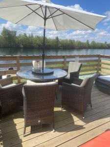 Award winning Serenity Lodge with outstanding lakeside views from the hot tub , at Tallington Lakes Leisure Park, Stamford