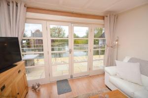 Dutch Cottage sits in its own basin off the River Bure in Horning