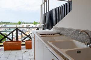 Welc-ōM Lignano swim and fun with dock view