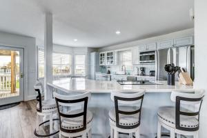 New Listing! Stunning Oceanfront 4-bedroom 3 bath house nestled on the quiet end of the island.