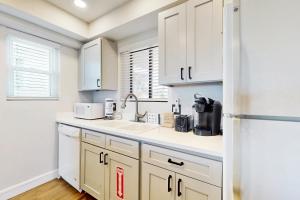 Modern oceanfront condo with outdoor pool, balcony, & washerdryer