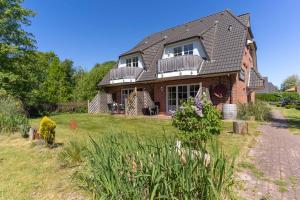 Ferienhaus Süderpiep – 4 individuelle Ferienwohnungen nahe Südstrand Ferienwohnung Auster – helle Maisonette mit 2 Schlafzimmern & Balkon