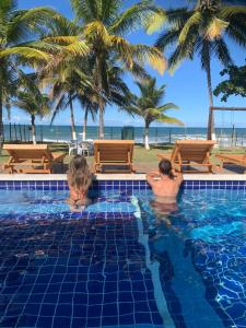 Casa completo com grande piscina sob coqueiros, pe na areia