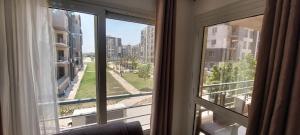 Fully finished 3-bedroom, 3-bathroom apartment with garden view in Jana Compound, Sheikh Zayed near Hyperone