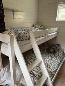 A simple stuga on a lake incinerating toilet in a separate building next to the cabin Water for drinking and washing hands dishes comes from two containers that attach to a faucet through a simple electric pump OBS no shower on site