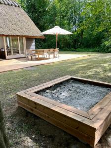 Be Surrounded By Trees In A Thatched Cottage