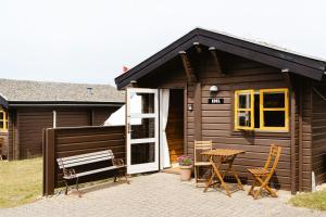 A Small Wooden Hut In A Large Community