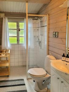 Black-Painted Log House Overlooking Vejle Fjord