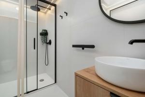 Blue and White Apartment in Łódź with Furnished Balcony by Noclegi Renters