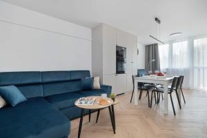 Blue and White Apartment in Łódź with Furnished Balcony by Noclegi Renters