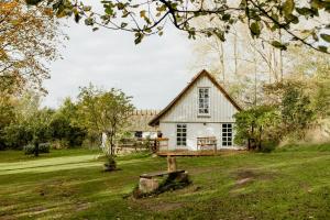 Thatched House Between Forest And Meadow