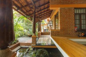 Kerala Style Villa by JadeCapsAC4BHKFishpond
