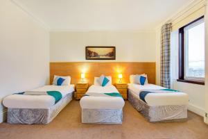 Standard Triple Room - Shared room in OYO Eastbank Hotel