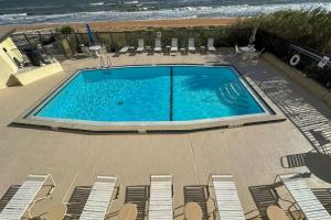 Luxury direct oceanfront corner with a large private balcony, heated pool and garage