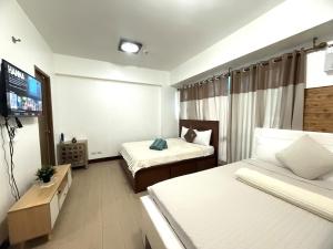 Kyedenz Unit -Two Palm Tree Villas Newport Naia T3 - Hôtels 4 étoiles à Manille