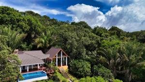 Relax At This Hillside Retreat That Overlooks The Lush Forest And The Caribbean