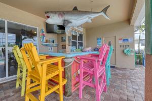 2790 Sq Ft, Open Concept, One Story Gulf Access Home with Private Dock and 20,000 lb Boat Lift, Fenced Yard, Heated Pool with Waterfall, Bikes, Fishing and Beach Gear, Family Ready and Dog Friendly!