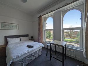 Ensuite triple room by Swansea University Hospital v