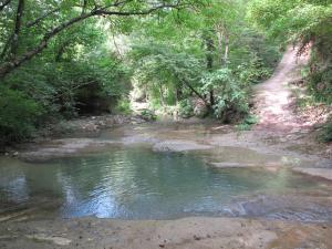 restored water mill with rockpools and waterfall