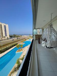 Home 1 | Ap Cinema Frente Mar com Piscina Aquecida em Bertioga