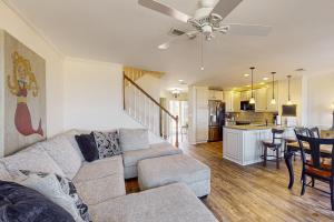 Oceanfront townhome with a furnished balcony, outdoor pool, & tennis