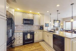 Oceanfront townhome with a furnished balcony, outdoor pool, & tennis