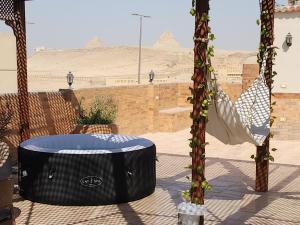 Private rooftop with jacuzzi and pyramids view