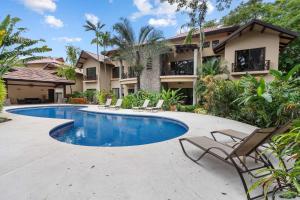 Modern Island-Themed Condo with Floor-to-Ceiling Windows & Garden and Pool Views Within Walking Distance of the Beach