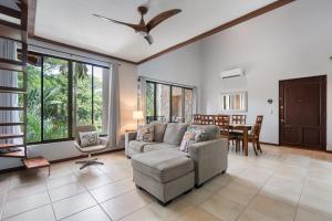 Modern Island-Themed Condo with Floor-to-Ceiling Windows & Garden and Pool Views Within Walking Distance of the Beach