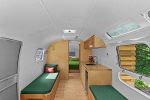 Sunlit Airstream in Trees with Expansive Deck Nature Views