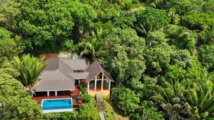 Relax At This Hillside Retreat That Overlooks The Lush Forest And The Caribbean,