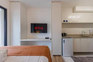 Studio com coworking, piscina e vista da cidade