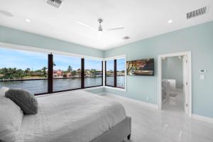 Luxe Waterfront Villa Walk to Beach Pool and Gym