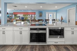 Pirates Den a 4BR Pet-Friendly Waterfront Oasis with Pool, Dock, Personal Water Boats, Fire Pit, Game Room and Bar