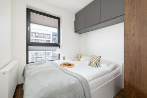 Light Grey Apartment in Cracow with Furnished Balcony by Noclegi Renters