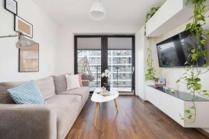 Light Grey Apartment in Cracow with Furnished Balcony by Noclegi Renters