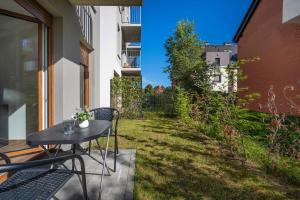 Elegant White Apartment with Terrace & Parking in Wrocław by Noclegi Renters