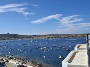 Bright Coastal Penthouse with Huge Terrace Overlooking the Sea- Ghadira Mellieha