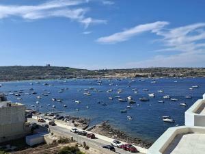 Bright Coastal Penthouse with Huge Terrace Overlooking the Sea- Ghadira Mellieha