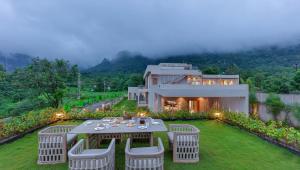 SaffronStays Grand Odyssy - 4BR luxury pool villa with sauna, game zone & lawn, perfect for weddings & parties in Karjat