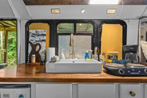 Covered Bridge Tiny Home Bus on the water in RRG