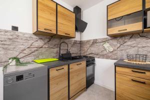 Blue and Green Family Apartment in Katowice with Two Bedrooms and Balcony by Noclegi Renters