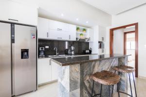 2BR Tropical Escape - Private Terrace, BBQ, Pool, Walk to Beach