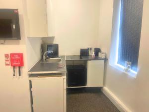 studio apartment with small kitchen and bathroom